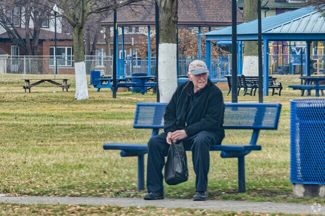 A man rests on a bench in Memorial Park in River Rouge.