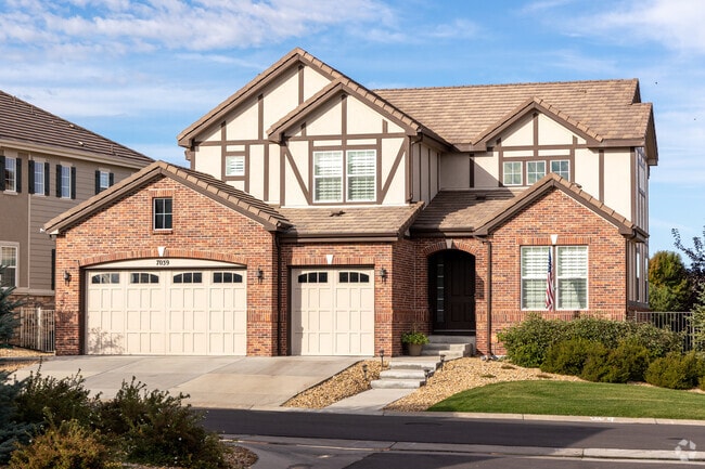 Saddle Rock Tudor-style home features outstanding brickwork and a three-car garage.
