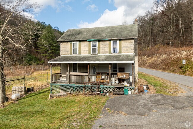 An old colonial revival home with its large porch soak up the sun along the main road in Taylor.