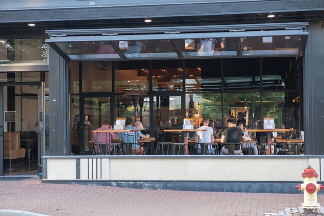 JJ Hadley opens the windows on a warm autumn day for fresh air near the Newburg neighborhood.
