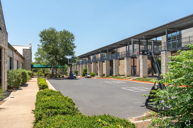 Classrooms at Trinity Episcopal School Of Austin overlook a basketball court.