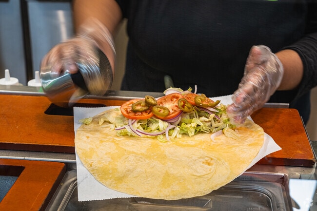 Salt and Pepper sprinkle a chicken wrap at Subway located in Med Center Sacramento.