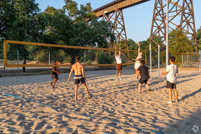Residents can play beach volleyball by the railroad bridge at Lake Redding Park.