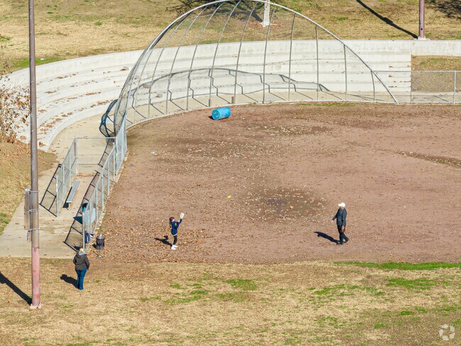 A grandfather and granddaughter play catch at Cypress Park in Tulare.