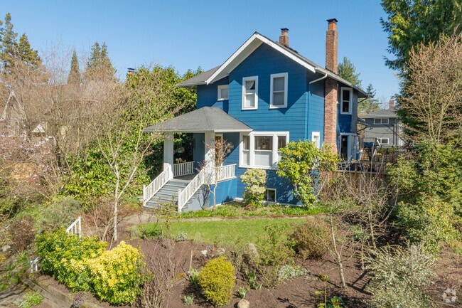 A charming home sits on a small landscaped lot in the University District.