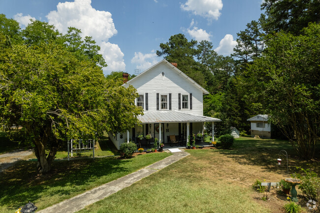 Older homes sit far away from the rode and are usually surrounded by trees.