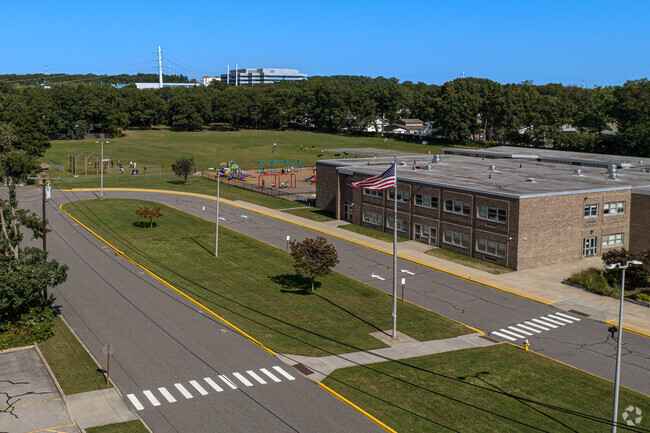 The school campus has a large field in the back.