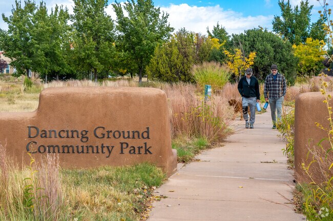 Locals walk their dogs at Dancing Ground Park which features wildflower meadows & playgrounds.