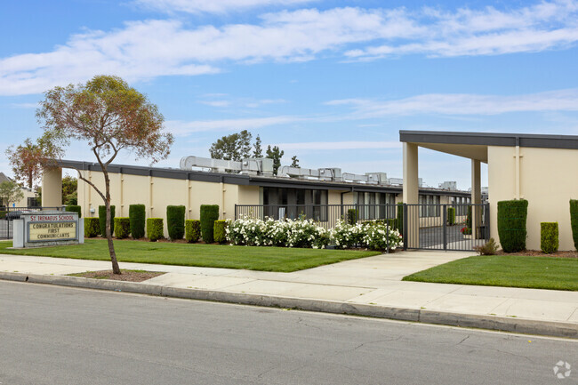 The entrance to St. Irenaeus Parish School in Cypress has rose bushes.