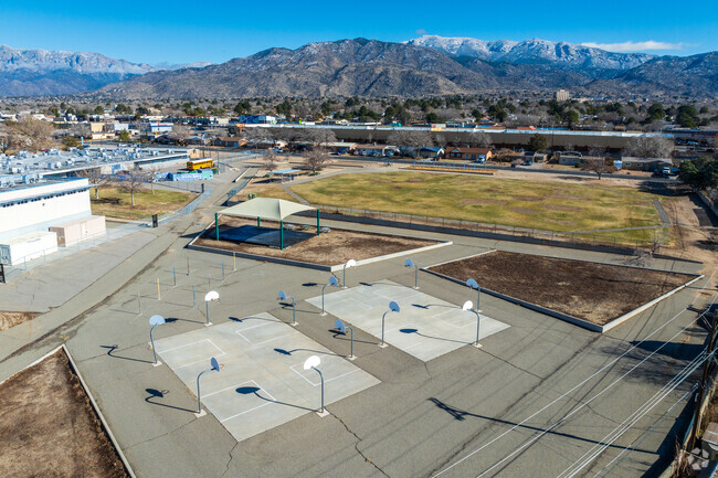 Basketball courts and a large grass field at Public Academy for Performing Arts in Albuquerque.