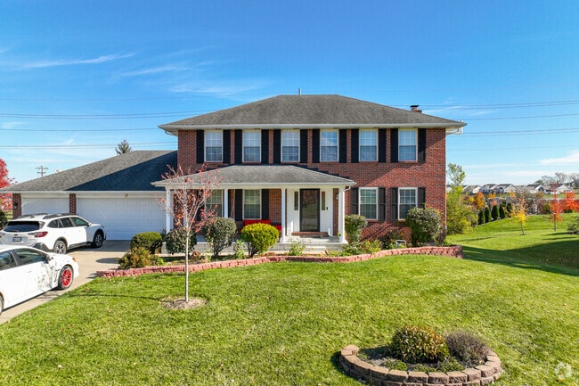 Beautiful landscape with this large brick colonial home in Liberty neighborhood.