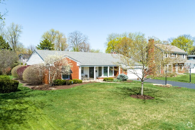 Ranch style home with a front porch and attached garage in Ridgewood.