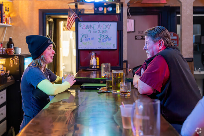 A Shepherd resident shares stories with the bartender at the Red Rooster Bar.