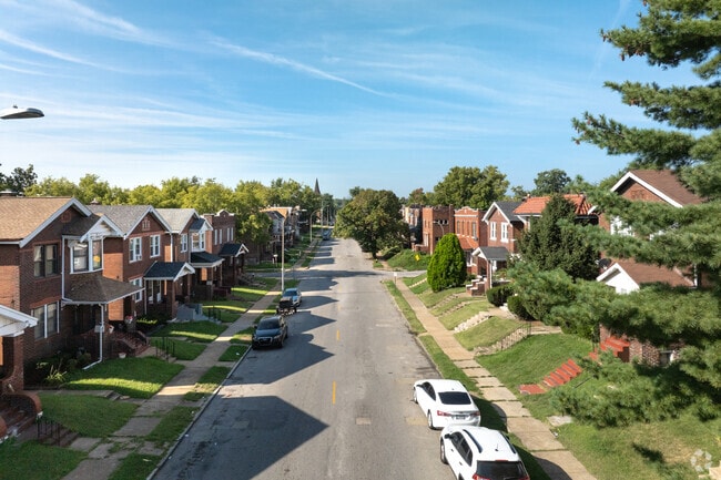 Red and brown brick homes line Penrose streets.