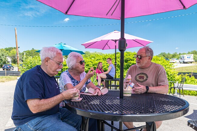 Locals enjoy sitting under the sunny umbrella enjoying their ice cream.