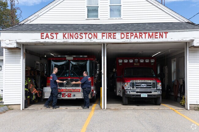 Firefighters pass off a hose during a calm moment at East Kingston Fire Department.