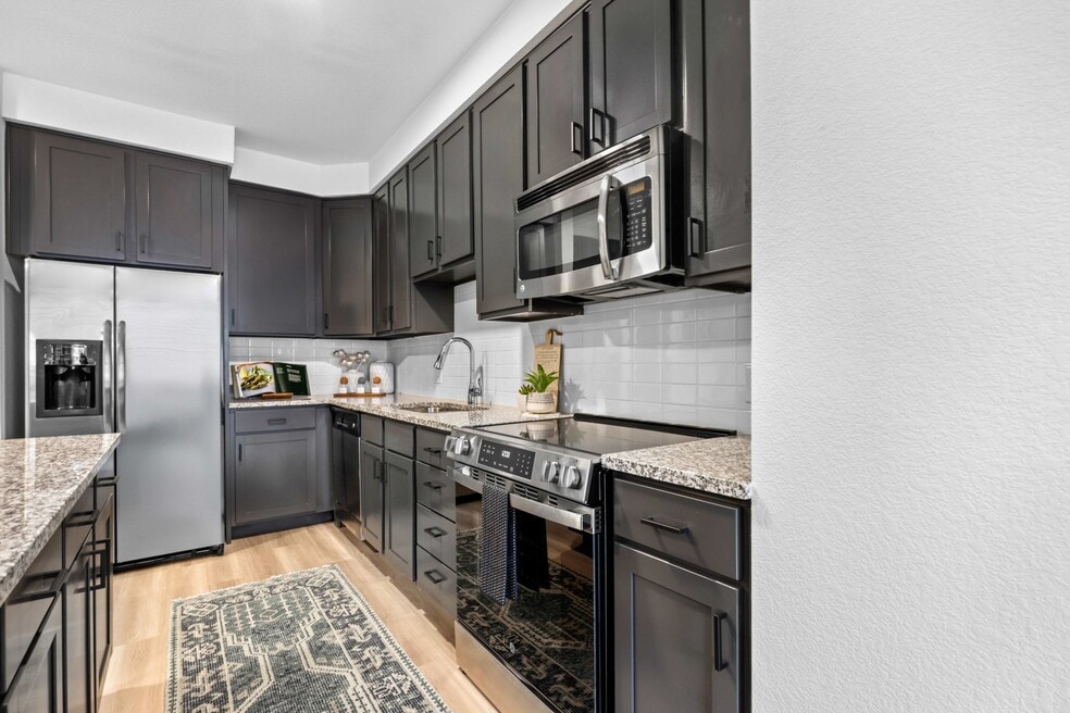 Upgraded kitchens with updated shaker style cabinets with sleek black hardware