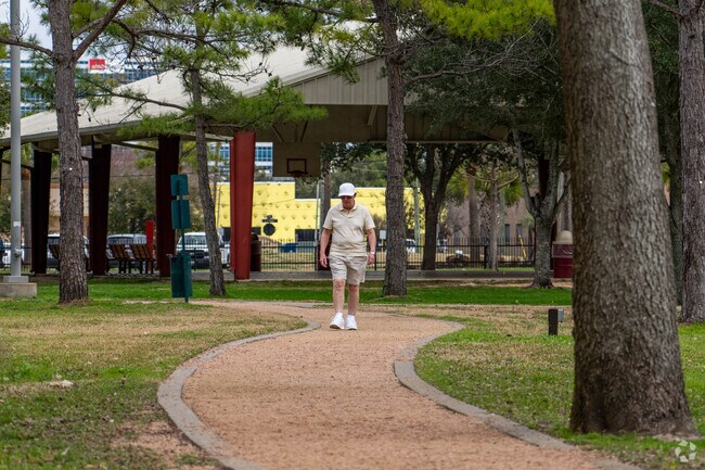 A resident enjoys a morning stroll along a walking trail in Webster.