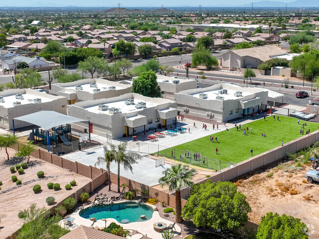 Cambridge Academy East offers a soccer field and a shaded playground for students.