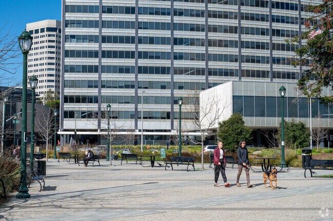 Residents take their furry friend for a walk through Snow Park in Oakland.