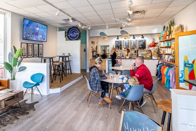 People enjoying coffee in a shop attached to a surf shop in Gulf Breeze.