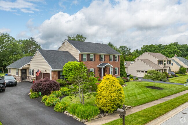 Colonial homes sit on sizable lots with attached driveways in Alapocas.