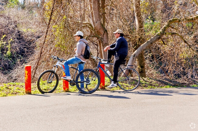 Cyclists enjoy a ride through River Cove in Riverbank, California.