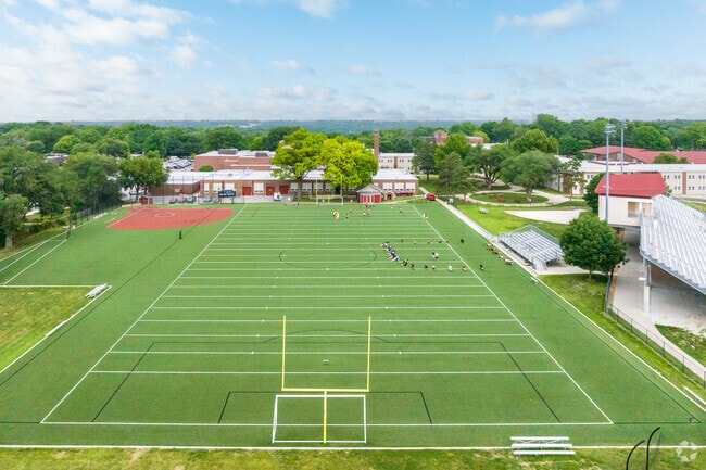 Shawnee Mission North has soccer field & their school colors are Cardinal Red, Black and White.