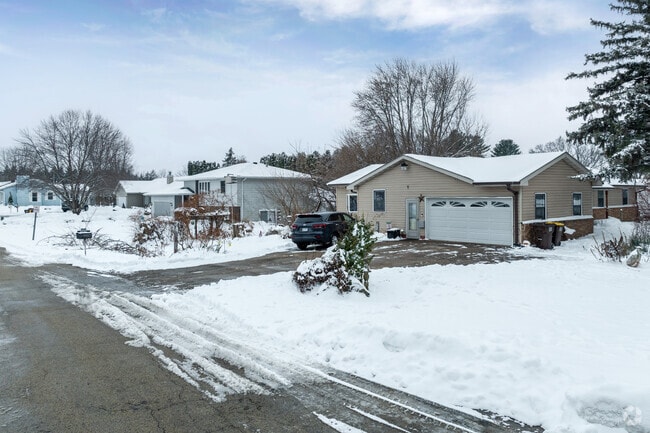 Quiet residential streets are dotted with smaller single-family homes, some with attached garages.