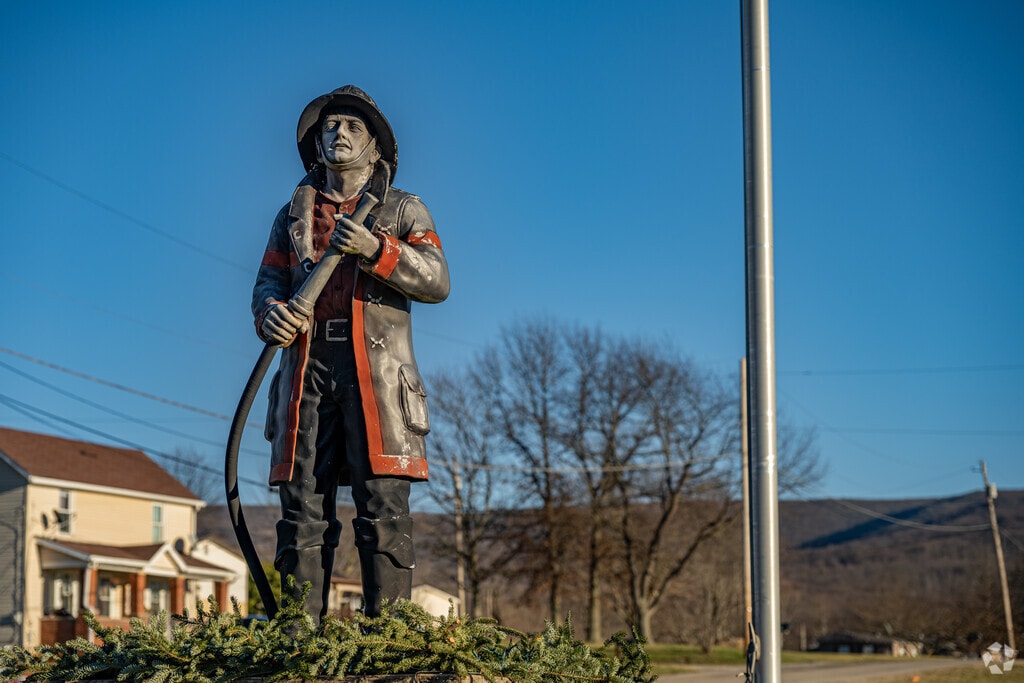 A statue of a firefighter pays tribute to the local firefighters in Georges Township Fayette.