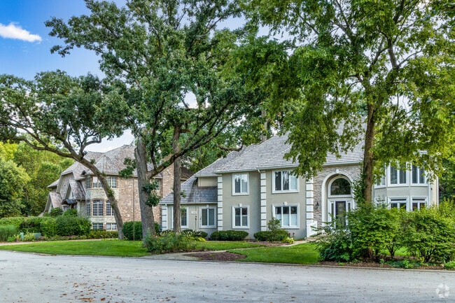 Mature trees provide shade and privacy for homes in Knoch Knolls.