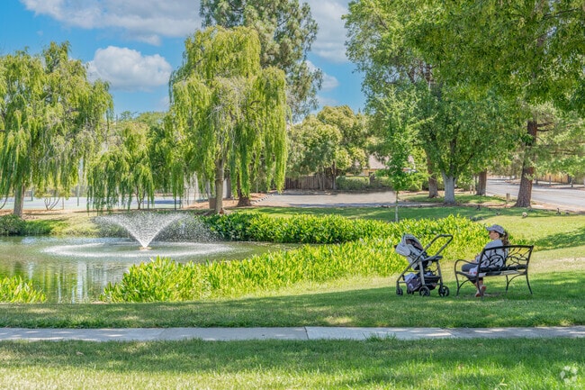 A mother sits with her young infant enjoying the serene surroundings in Midtown Concord.