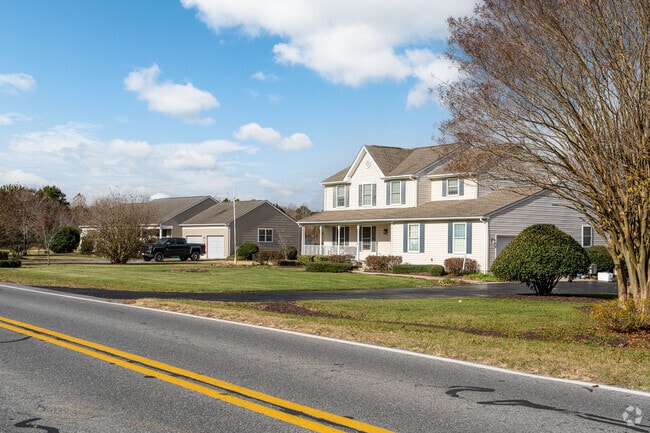 A colonial style home shares a street view with its ranch neighbor in Ocean View.