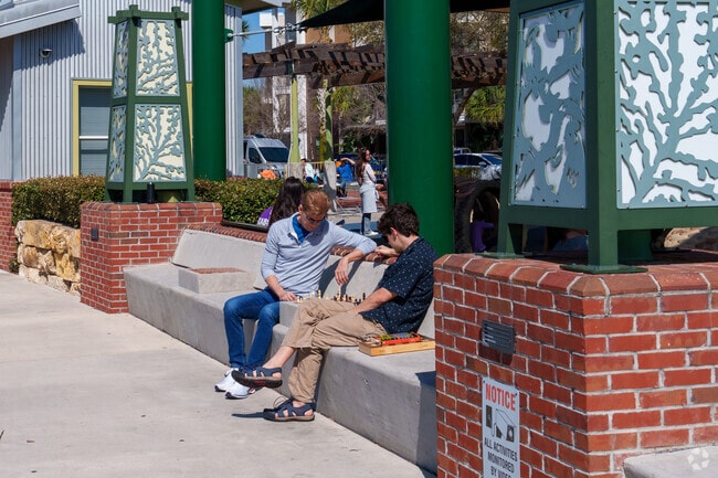 On pleasant afternoons, Live Oak Reserve residents often gather for a friendly game of chess, enjoying both the sunshine and the sense of community.