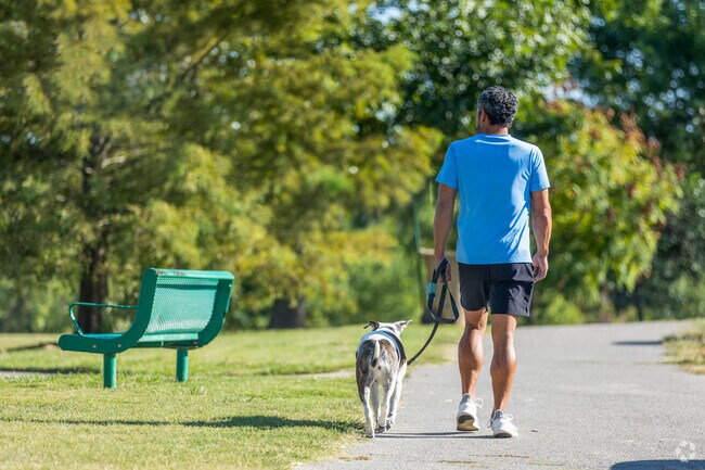 Residents enjoy a tranquil stroll through Hunter Park's scenic trails.
