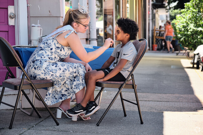 A child gets his face painted by an artist at West Virginia Fest.