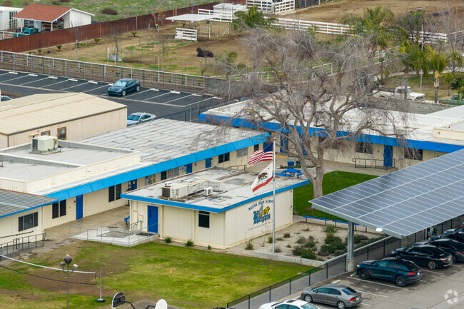 The flags fly high in the front of Nueva Continuation School.