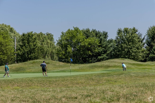 Golfers at Grey Hawk Golf Club practice putting in neighboring LaGrange.