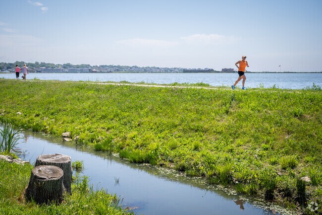Runners and walkers enjoy nature by Easton Pond, with a bay view in Easton Pond, RI.
