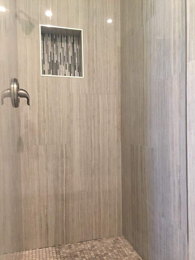 tiled primary en-suite shower walls.
