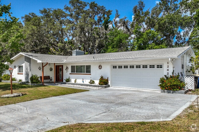 Neighbors live in Midcentury Minimal homes with large driveways.