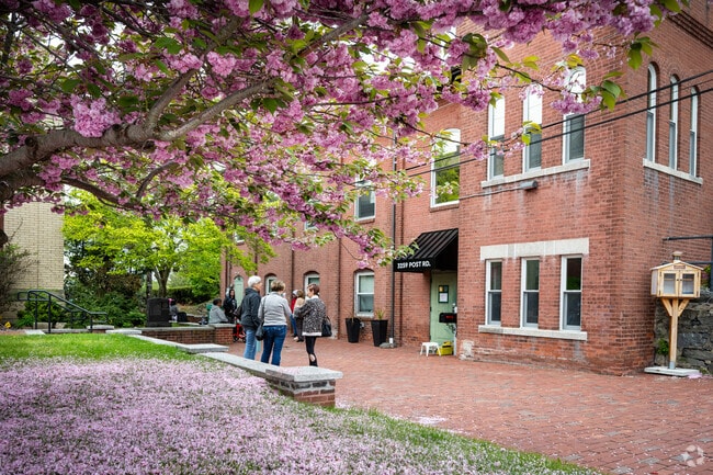 On a beautiful spring day, people waiting to see the art show at the Warwick Art Center.