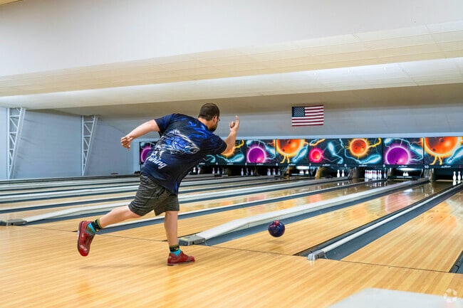 A bowler rolls the ball down the lane at Meyer Maple Lanes in Maple Avenue District.