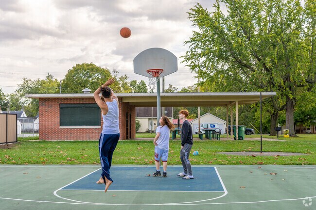 Neighborhood Empowerment youths enjoy a game of hoops.