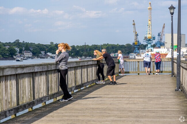 Tourists gather on the pier in Portsmouth to view the Piscataqua River in Newington.