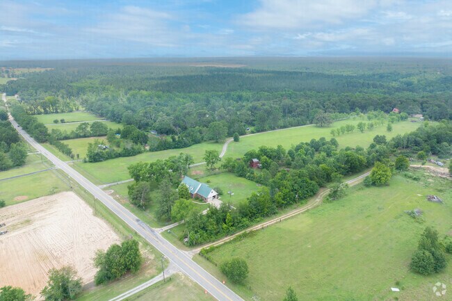 The sprawling green pastures surrounding McBean help define its rural charm and open, airy character.