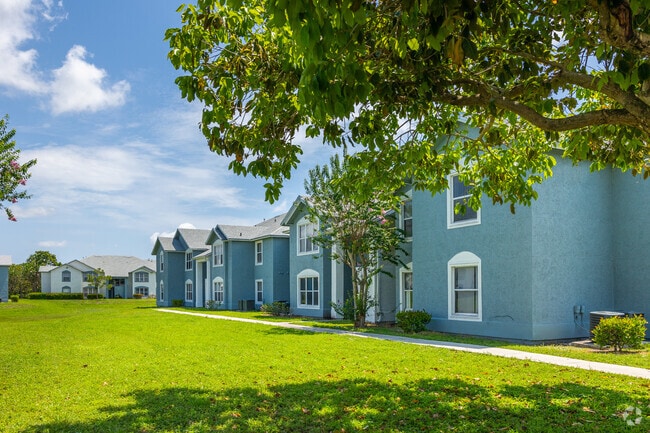 Colorful townhouses with large green garden in Lone Pines neighborhood.