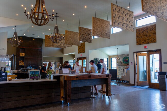 Guests gather around a rustic table at Brys Estate’s tasting room on Old Mission Peninsula.