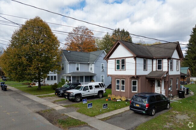 Some homes have gravel lots for parking.