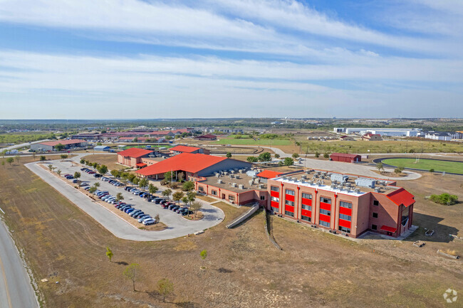 The red roofs of the Manor campus stand out against the open land that surrounds.